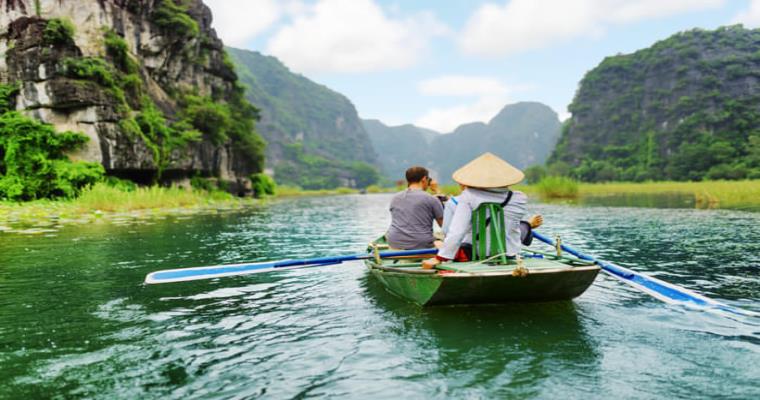 boat ride through a landscape reminiscent of tam coc bich dong in ninh binh province vietnam or possibly ha long bay