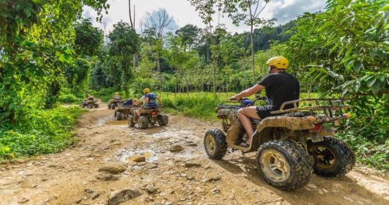 atv rides through muddy forest trails